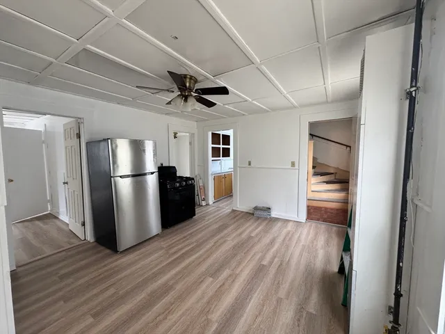 a view of a refrigerator in kitchen and wooden floor