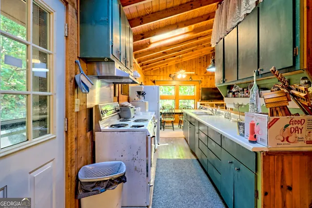 a spacious bedroom with a bed and a chandelier