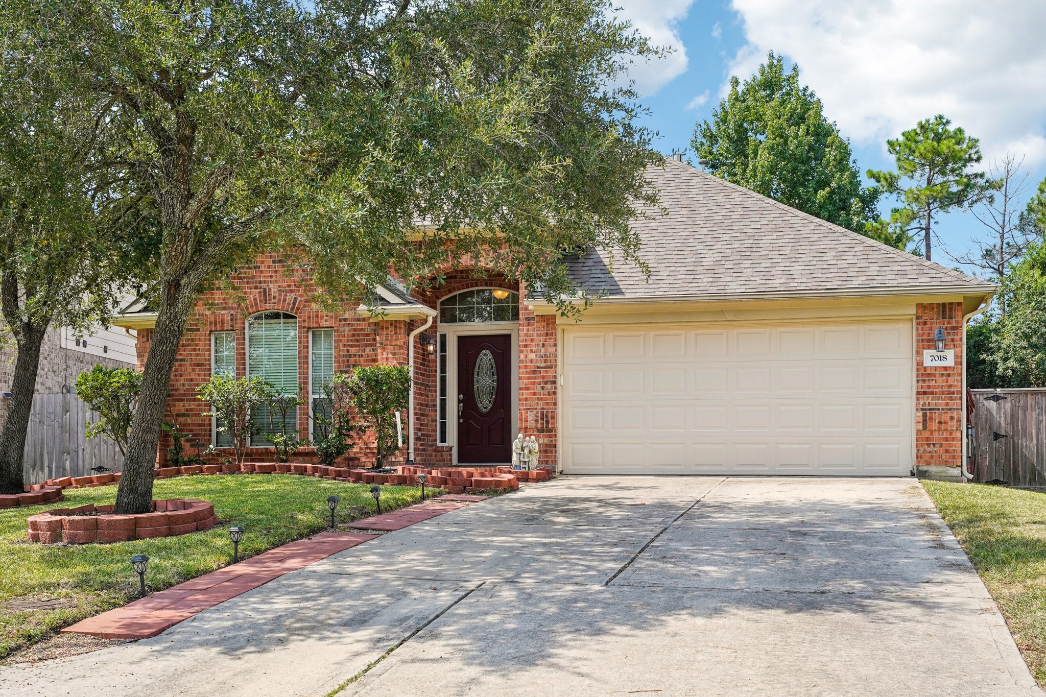 Charming single-story brick home with a two-car garage, mature trees, and a well-maintained front yard.  Ideal for comfortable suburban living.