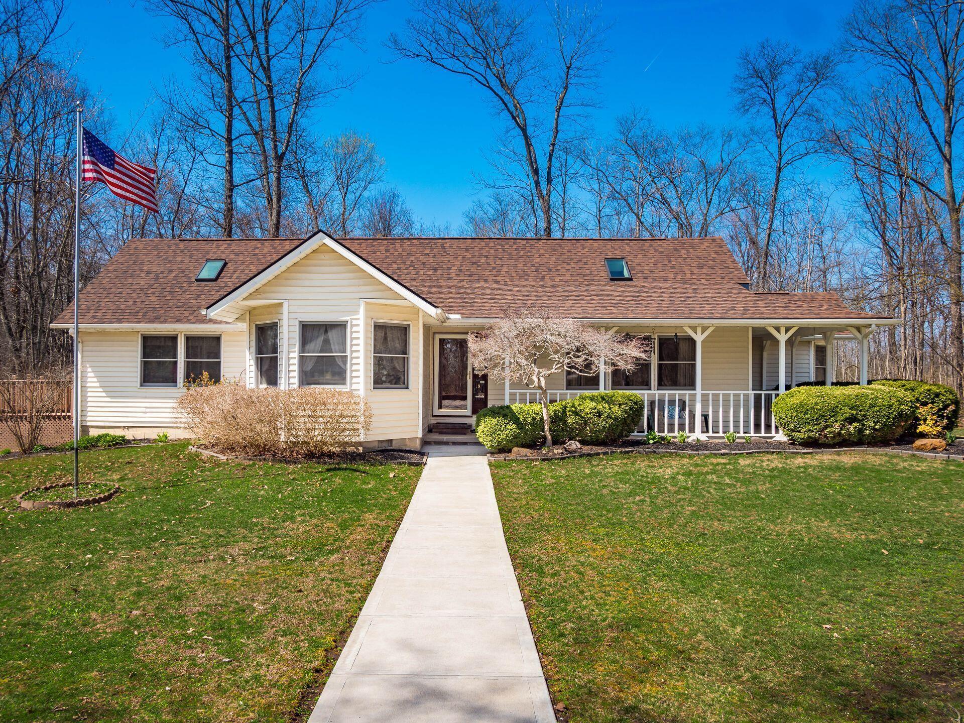 Welcome to this cozy wooded ranch home with a wide front porch and large 3-acre lot!