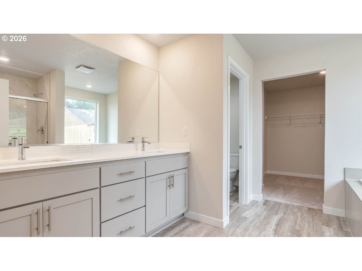 9194 Southeast Azalea Street Happy Valley, OR 97086 - Photo 27 of 32 a bathroom with a sink a mirror and a shower