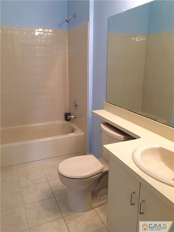 313 Wimbeldon Court North Brunswick, NJ 08902 - Photo 11 of 17 a bathroom with a sink a toilet and shower