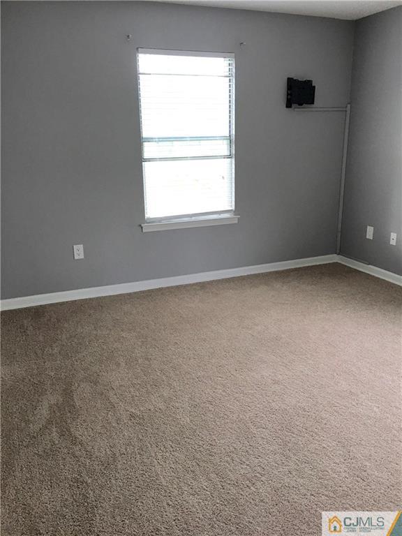 313 Wimbeldon Court North Brunswick, NJ 08902 - Photo 13 of 17 an empty room with a window