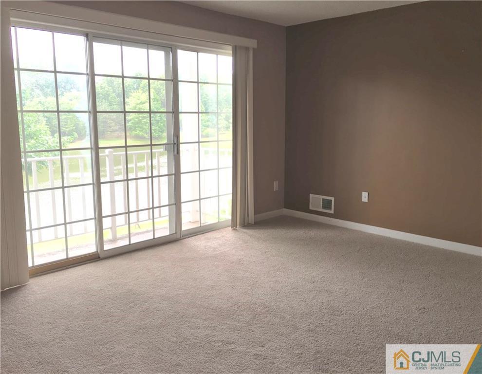 313 Wimbeldon Court North Brunswick, NJ 08902 - Photo 4 of 17 a view of an empty room with a window