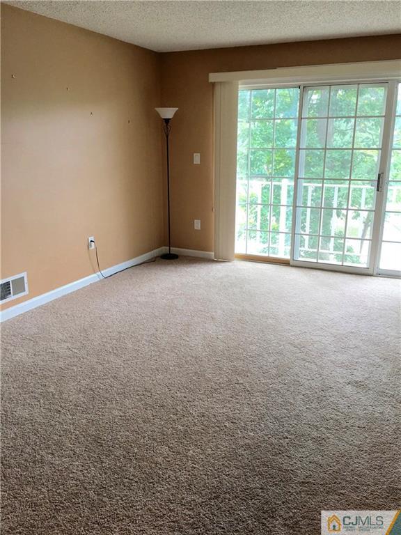 313 Wimbeldon Court North Brunswick, NJ 08902 - Photo 5 of 17 a view of an empty room with a window