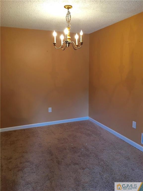 313 Wimbeldon Court North Brunswick, NJ 08902 - Photo 6 of 17 a view of a chandelier fan and windows