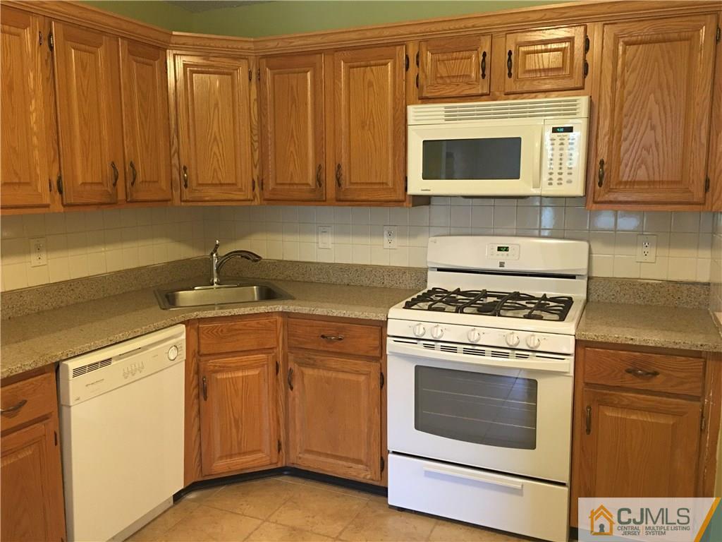 313 Wimbeldon Court North Brunswick, NJ 08902 - Photo 8 of 17 a kitchen with granite countertop cabinets stainless steel appliances and sink