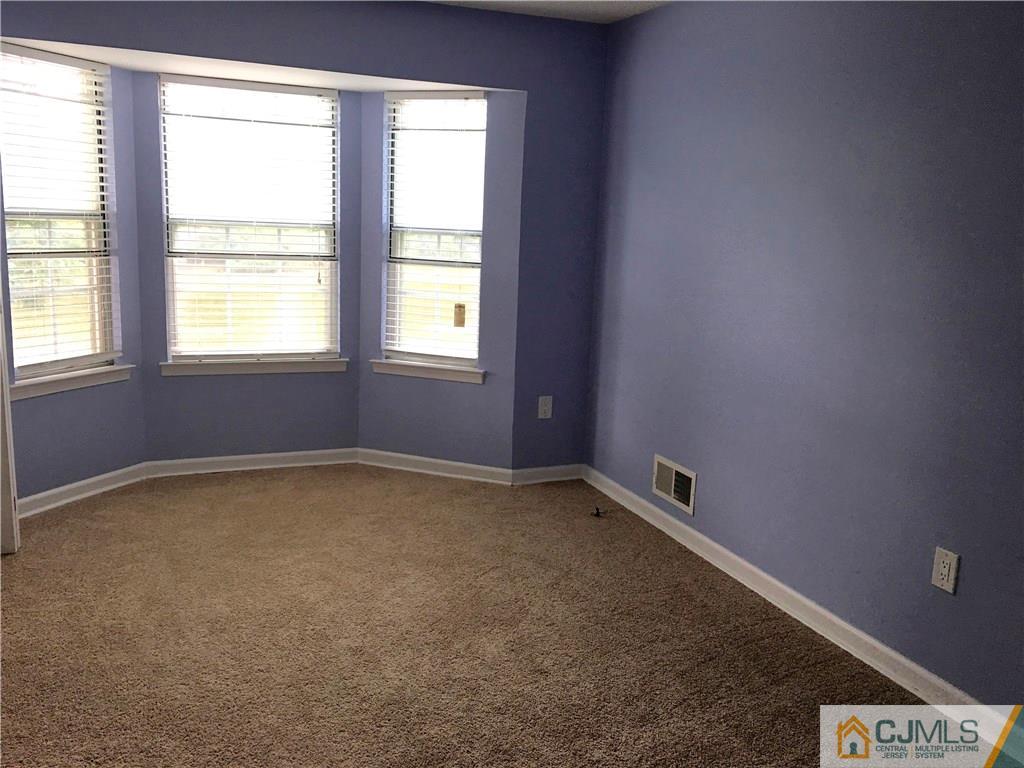 313 Wimbeldon Court North Brunswick, NJ 08902 - Photo 10 of 17 an empty room with a window