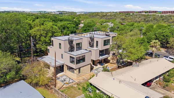 an aerial view of a house with a yard