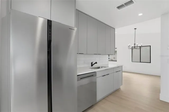 a kitchen with a sink and refrigerator