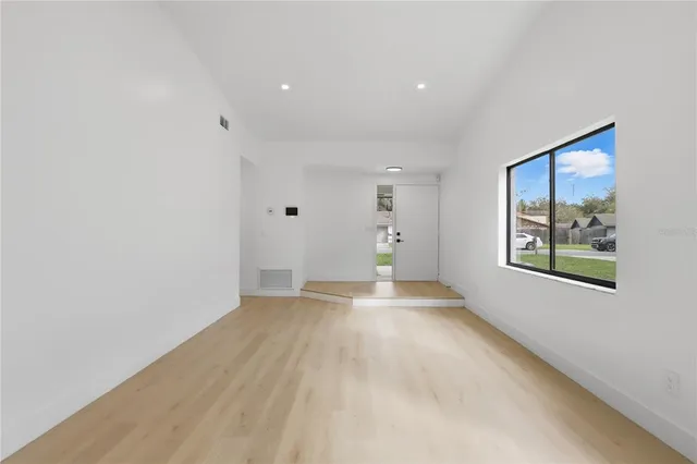 a view of an empty room with a window