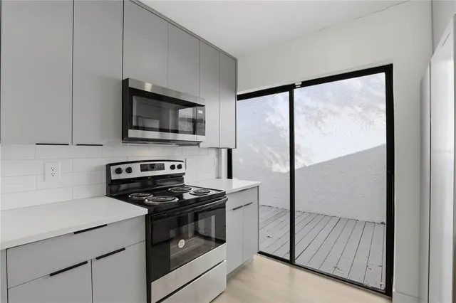 a kitchen with wooden cabinets and a stove top oven