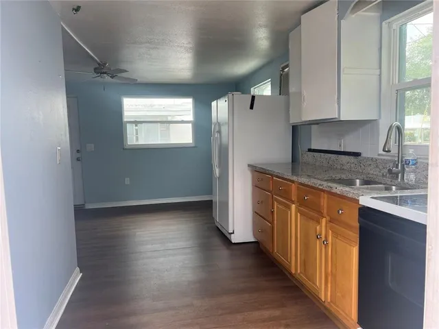 a kitchen with stainless steel appliances granite countertop a stove a sink and a refrigerator