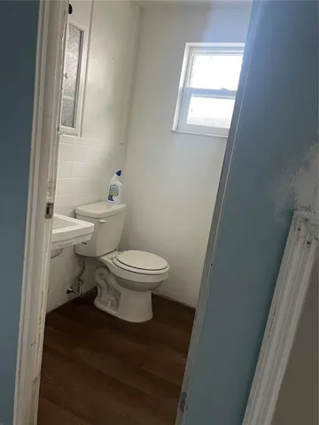 a white toilet sitting next to a bathroom sink