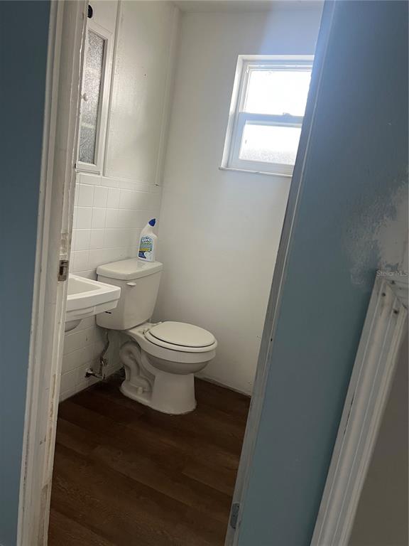 5206 7th Street Zephyrhills, FL 33542 - Photo 7 of 10 a white toilet sitting next to a bathroom sink