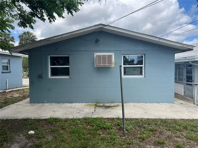 a house that has a tree in front of it