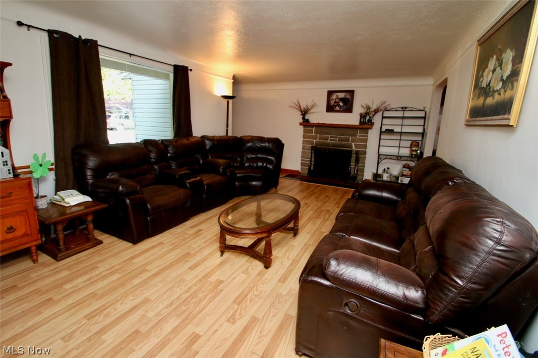 3 Nepahwin Road Timberlake, OH 44095 - Photo 4 of 22 Cozy living room area with wood burning fireplace and easy to maintain laminated flooring. Spacious room will accommodate the largest furniture.