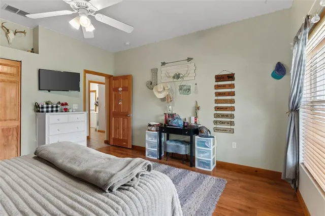 a bedroom with a bed and a television