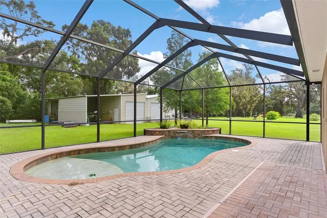 a view of a backyard with swimming pool