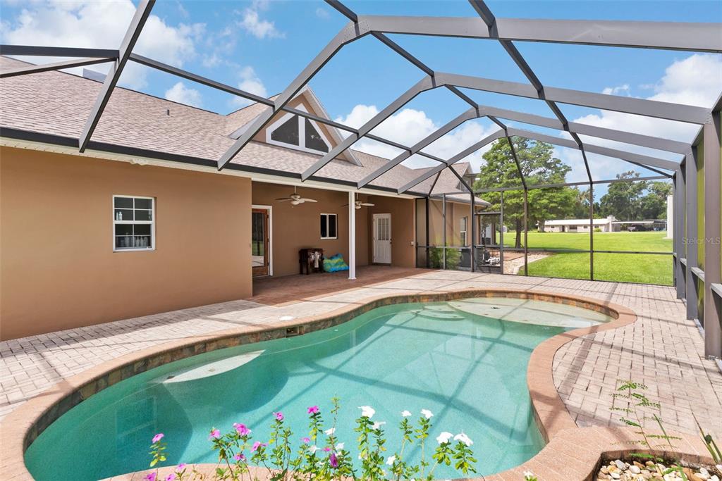 12136 McIntosh Road Thonotosassa, FL 33592 - Photo 25 of 44 a view of a backyard with a patio and a garden