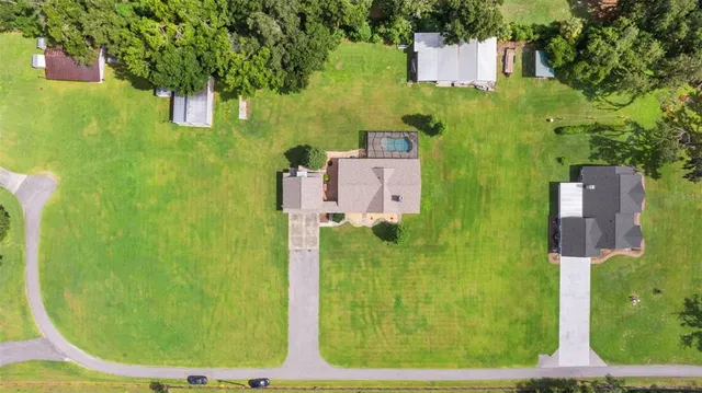an aerial view of a house with a yard