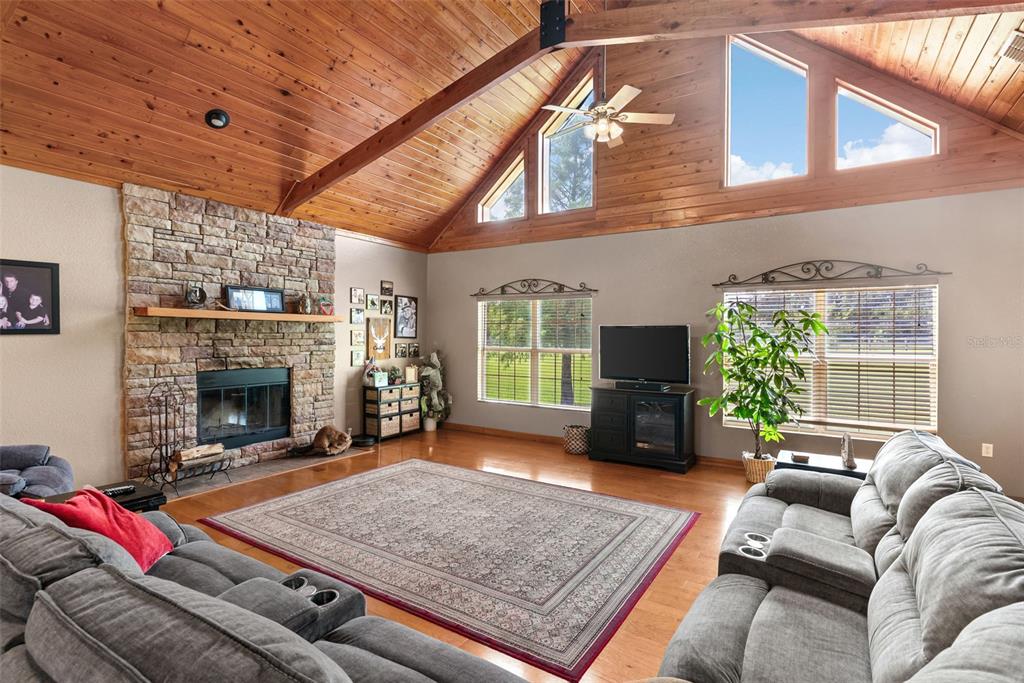 12136 McIntosh Road Thonotosassa, FL 33592 - Photo 9 of 44 a living room with furniture large window and a fireplace