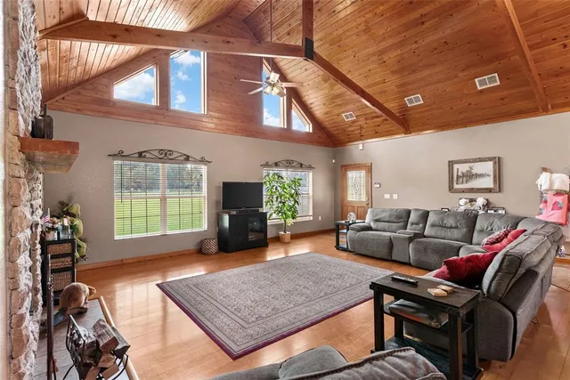 a living room with furniture a fireplace and a flat screen tv