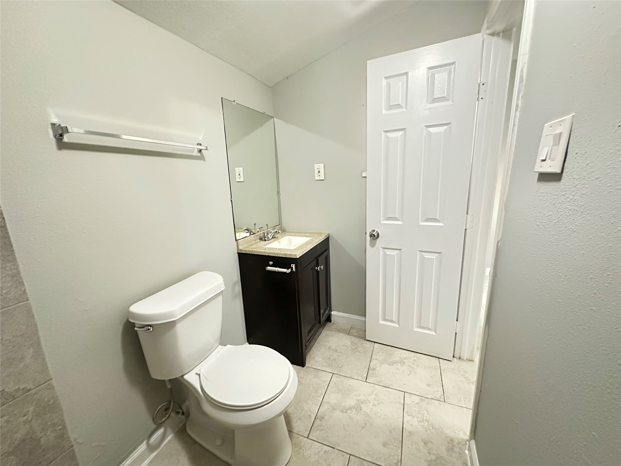 107 Altic Street, Unit 3 Houston, TX 77011 - Photo 12 of 13 a white toilet sitting next to a bathroom sink