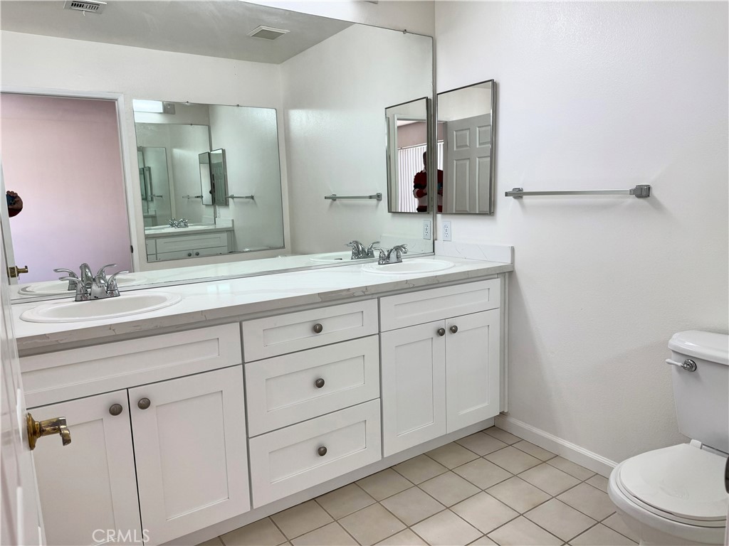 18319 Hart Street, Unit 3 Reseda, CA 91335 - Photo 13 of 18 a bathroom with a toilet sink and mirror