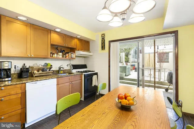 a kitchen with a sink appliances cabinets and furniture