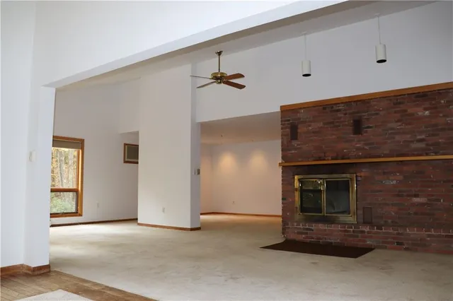 a view of an empty room with a fireplace