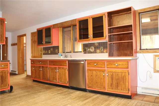 a spacious bathroom with a granite countertop sink and washing machine