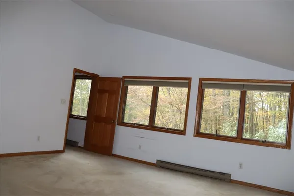 an empty room with large windows