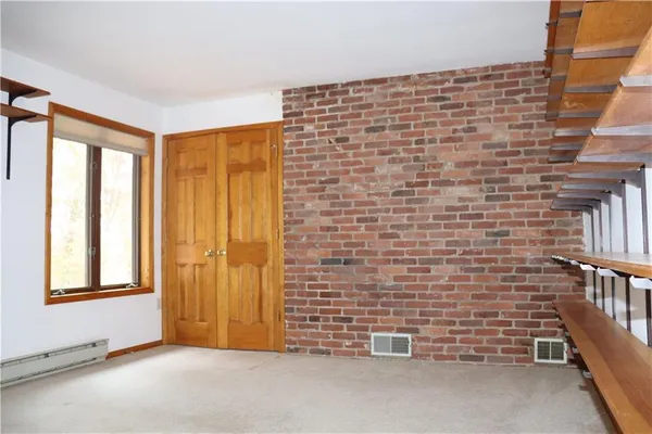 a view of an empty room and a window
