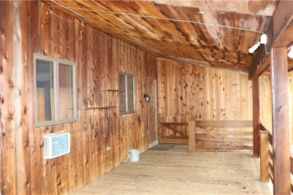 a view of a wooden deck next to a yard