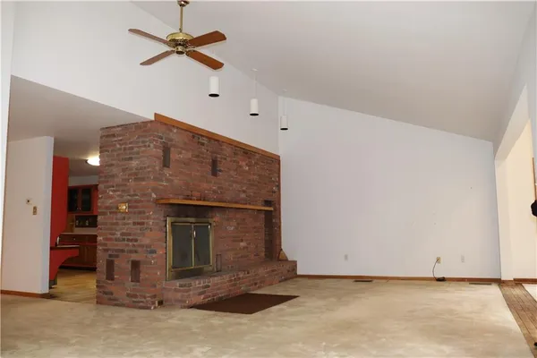 a view of an empty room with a fireplace
