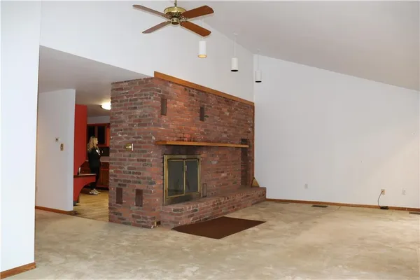 a view of an empty room with a fireplace