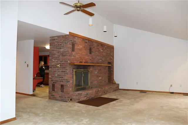 a view of an empty room with a fireplace