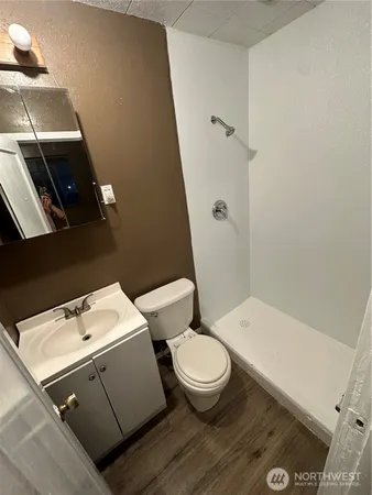 a white toilet sitting next to a bath tub