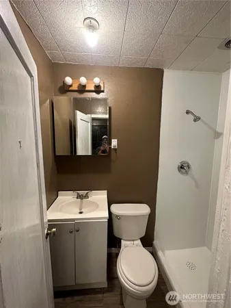 a bathroom with a toilet and a shower