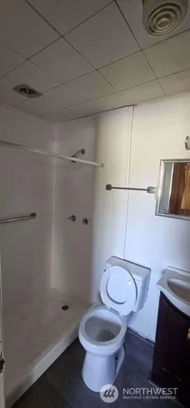 a bathroom with a sink a toilet and a mirror