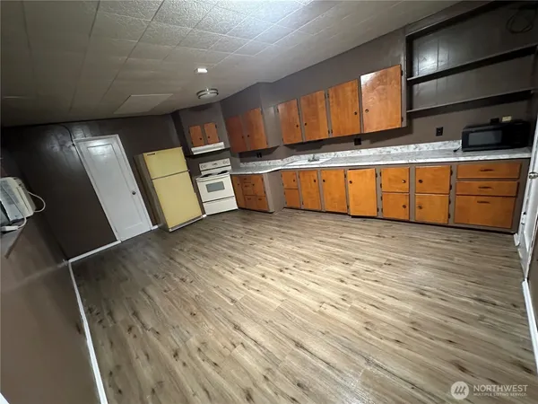 a kitchen with stainless steel appliances granite countertop a sink a stove and cabinets