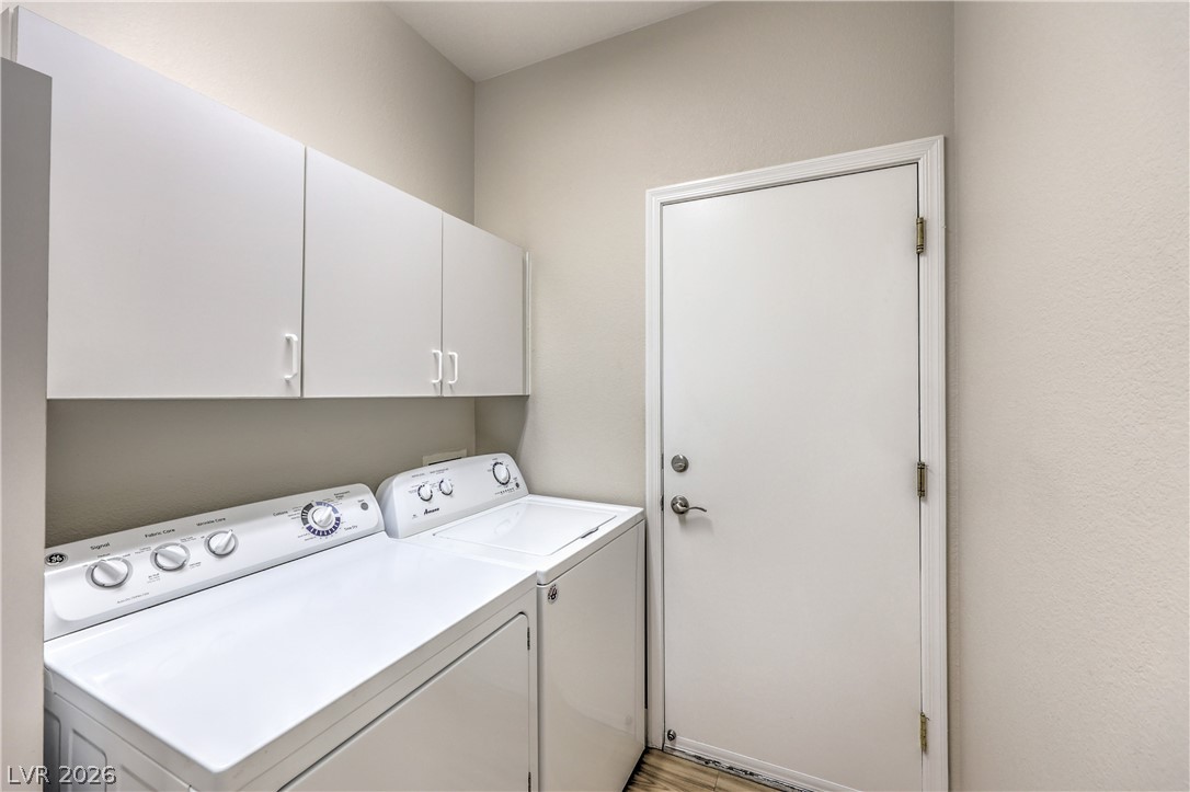 2072 Crown View Street Henderson, NV 89052 - Photo 31 of 53 Laundry Room with Utility Sink, Cabinets, and Washer & Dryer