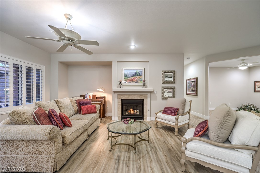 2072 Crown View Street Henderson, NV 89052 - Photo 5 of 53 Spacious Great Room with Ceiling Fan, Gas Fireplace, Laminate Wood Flooring, and French Doors leading to Backyard