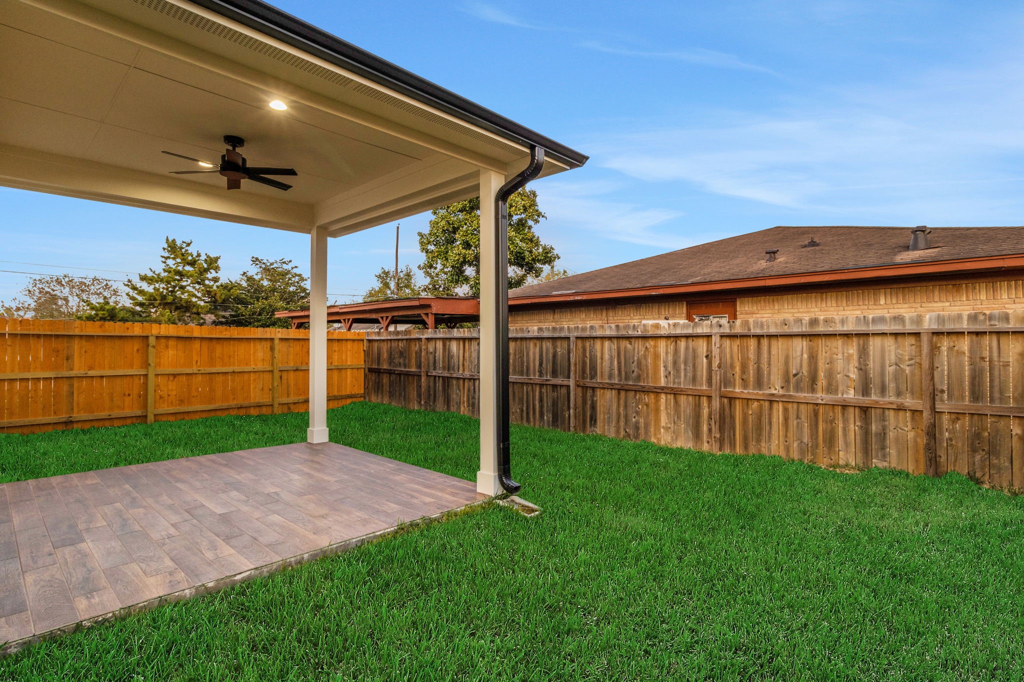 4202 Plaag Street Houston, TX 77016 - Photo 4 of 38 Enjoy year-round comfort on the covered patio complete with ceiling fan and tile flooring.