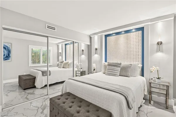 a bedroom with a bed and a couch