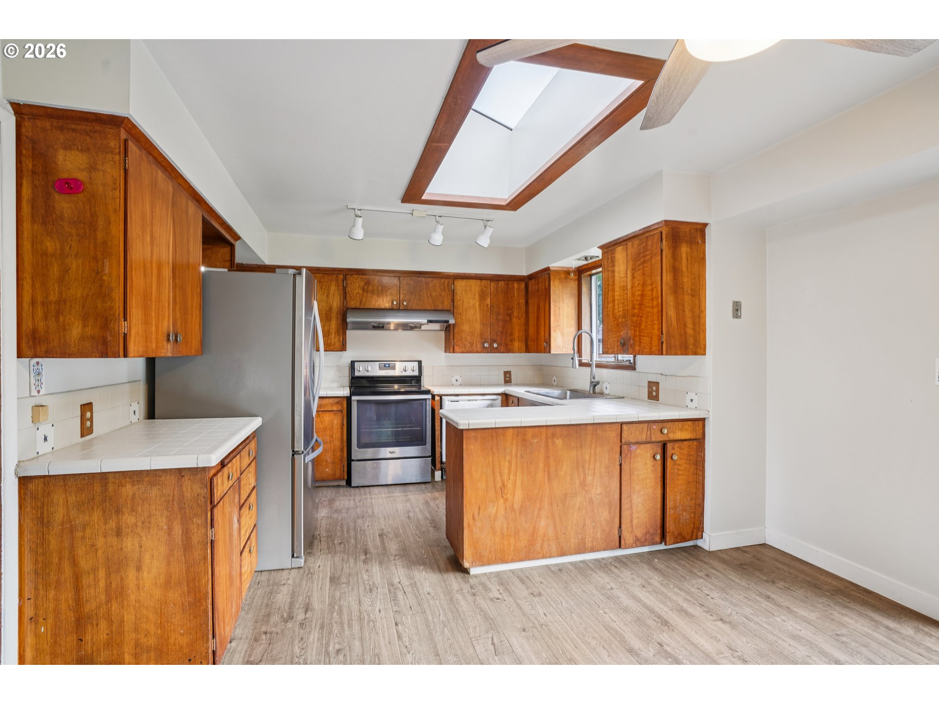 2530 Southeast 190th Avenue Gresham, OR 97030 - Photo 11 of 35 a kitchen with stainless steel appliances granite countertop a sink a stove and a refrigerator