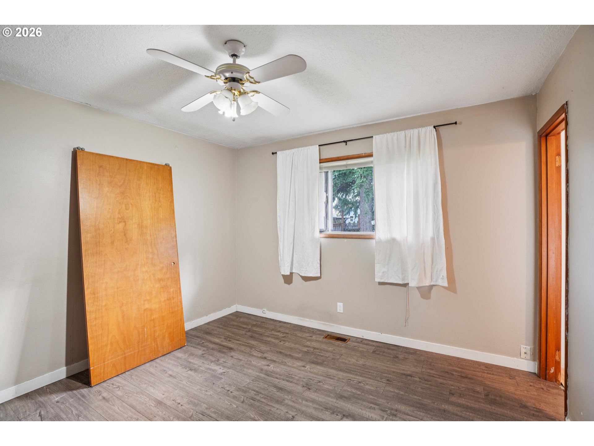 2530 Southeast 190th Avenue Gresham, OR 97030 - Photo 16 of 35 a view of an empty room with wooden floor and a window