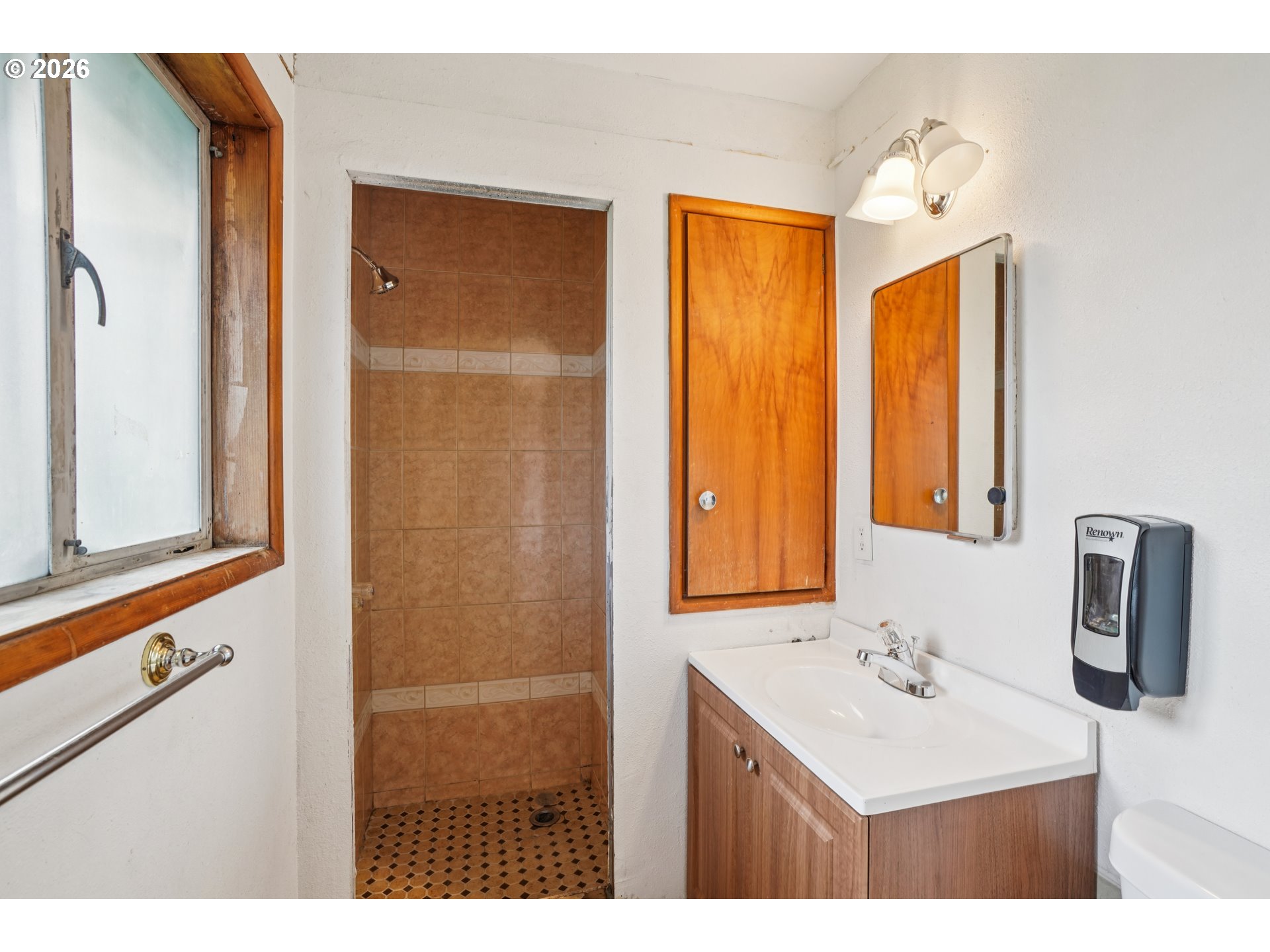 2530 Southeast 190th Avenue Gresham, OR 97030 - Photo 19 of 35 a bathroom with a sink a mirror and a shower