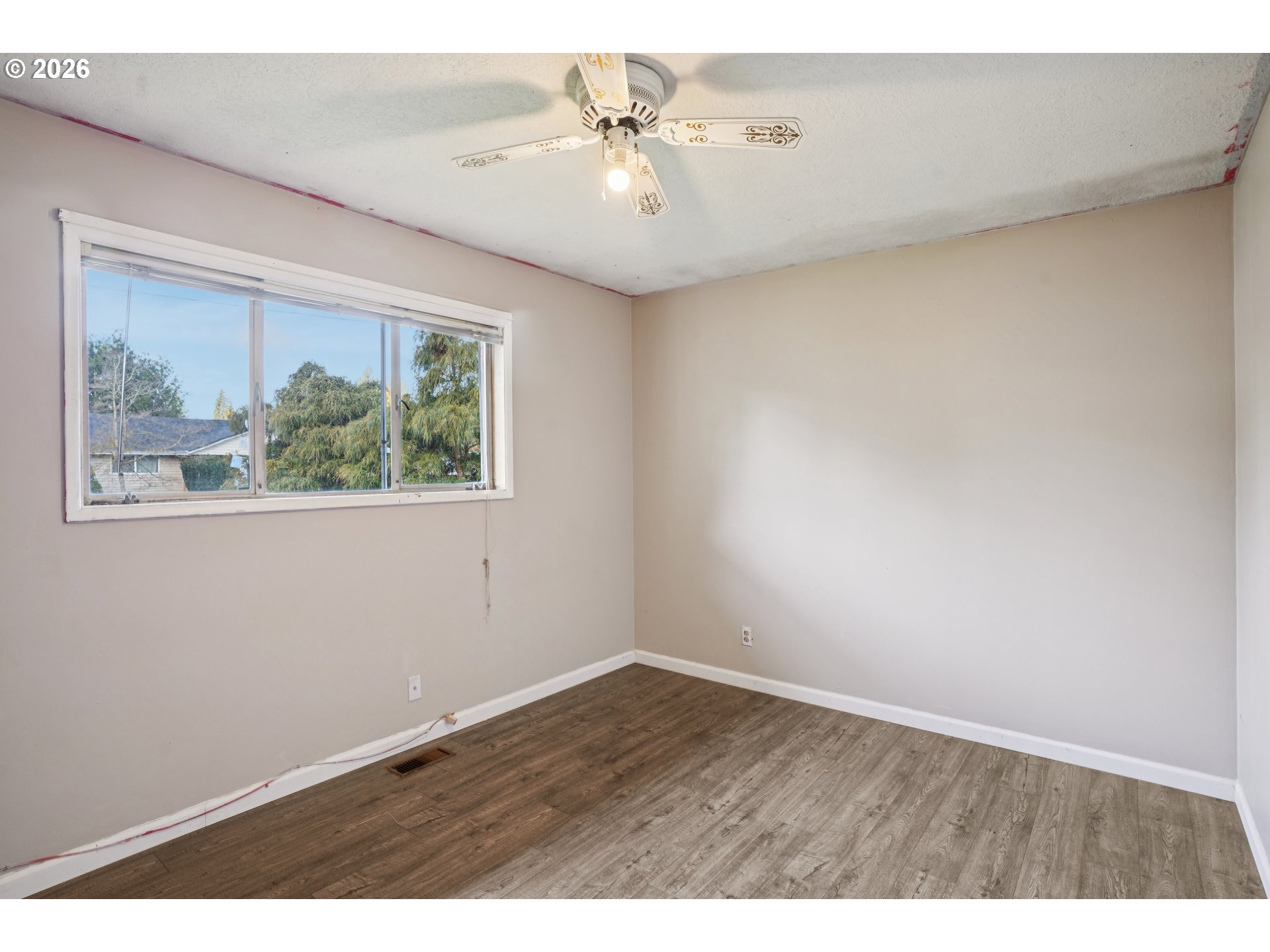 2530 Southeast 190th Avenue Gresham, OR 97030 - Photo 20 of 35 an empty room with a window and a ceiling fan